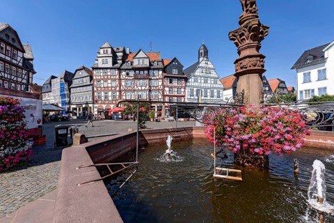 Kump, medieval market fountain with geraniums, decor, row of houses, half-timbered houses Gasthaus