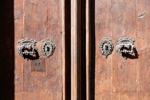 Old door lock and door knocker on a wooden door in Barcelona, Spain