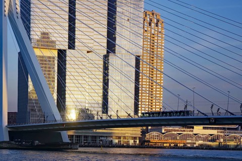 Detailed view of a modern rope bridge and skyscrapers in the background at sunset, Maas, Erasmus