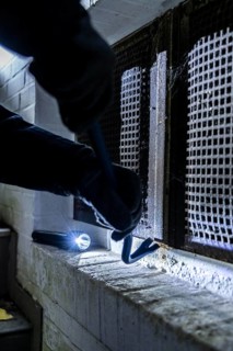 Symbolic image of a house burglary, perpetrator has approached a house from the garden side and