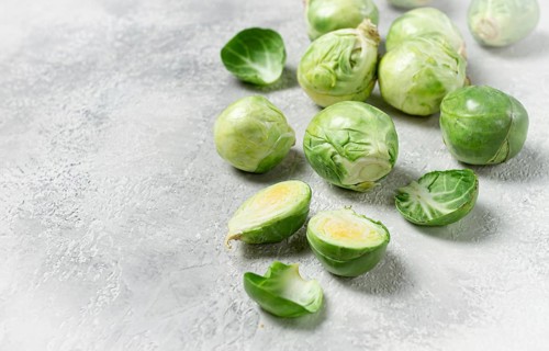 Fresh Brussels sprouts, raw, top view, on a gray table, no people