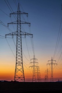 High-voltage pylons, overhead power lines at sunset. Schwieberdingen, Baden-Württemberg, Germany