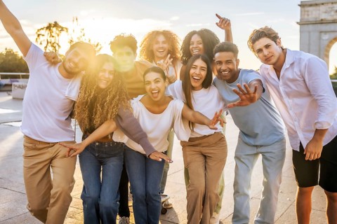 Portrait of multi-ethnic friends having fun during sunset in the city