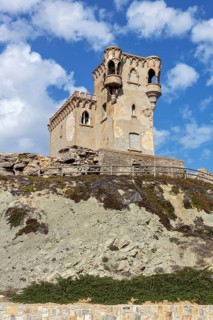 Old tower on a rock under a bright blue sky, Tarifa