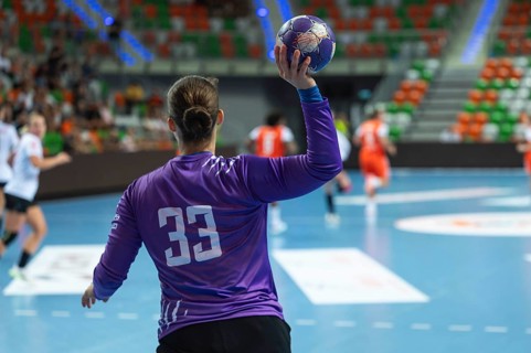 Handball goalkeeper woman throw out the ball during the game