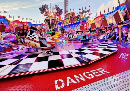 People on the illuminated carousel Break Dance in the evening, Cranger Kirmes, Herne, Ruhr area,