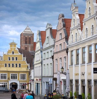 Historic houses, at the back the remaining tower of St Mary's Church, Wismar,