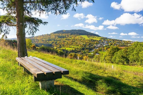 Bench with view of the Pöhlberg with Geyersdorf in autumn, Erzgebirge, Saxony, Germany