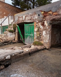 Old and dilapidated boat shelters that are not being used, old port area in Portocolom on the east