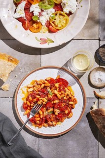 Top view of a homemade meal featuring freshly made pasta coated in a rich tomato sauce,