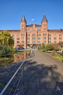 New town hall, brick architecture, architectural style neo-gothic, park, trees, footpath, pond,