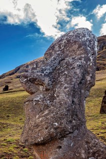 Close-up of a Moai statue with dramatic cloudscape in the background, The Moai statues on Easter