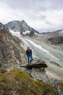 Mountaineer at Col de Riedmatten, view of glacier Glacier de Cheilon and mountain peak Mont Blanc