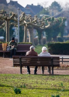 Krefeld, North Rhine-Westphalia, Germany - Senior citizens sitting on a park bench in the district