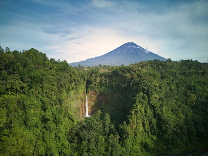 A breathtaking landscape showcasing the towering Mount Semeru volcano and the stunning Kaspa Biru
