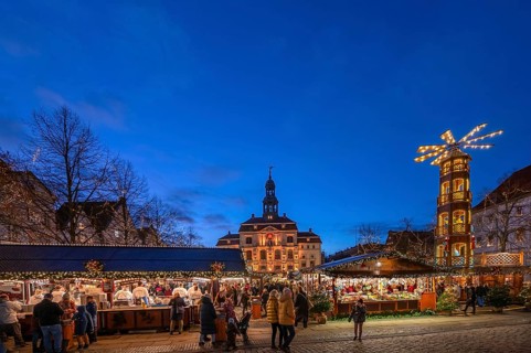 Christmas market with large Christmas pyramid on the market square, behind the historic town hall,