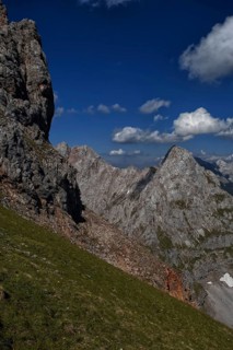 Steep mountain slope with cloud formations over blossoming landscape, Karwendel, Mittenwald,