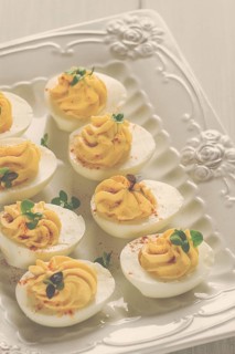 Boiled eggs stuffed with yolk with mayonnaise, on a white plate, selective focus, blurry, close-up,