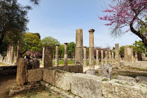 Restored ruins and blossoming trees, Palaestra, Ancient Olympia in spring, archaeological site,
