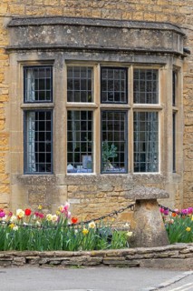 Honey-coloured house, windows, flowers, Bourton-on-the-Water, The Cotswolds, Gloucestershire,
