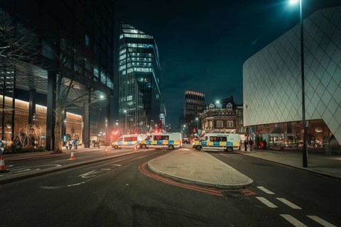 Street scene in a modern city at night with illuminated buildings and wide street, New Year's Eve