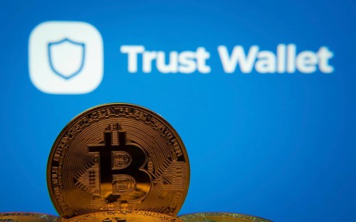 Dhaka, Bangladesh- 30 Sep 2025: Close-up of Bitcoin coins with the Trust Wallet logo visible on a