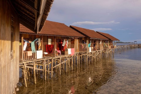 Rustic stilt houses on Waigeo Island, part of the stunning Raja Ampat Archipelago surrounded by
