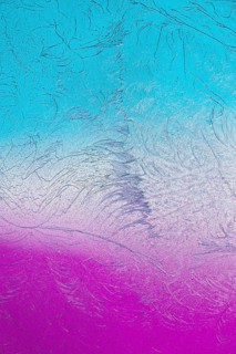 A vivid display of microcrystals under the microscope showcases intricate patterns in shades of
