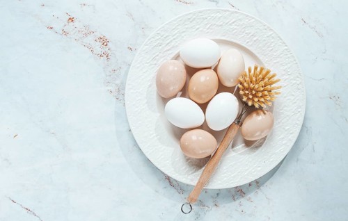 The concept of health care, the fight against salmaniasis, washed chicken eggs, on a white plate,