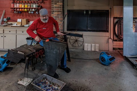 Glass blower demonstrates the art of blowing glass at the Dollywood amusement park in Pigeon Forge,