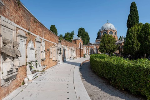 Graves on a wall, behind the dome of St Christopher's Church, San Michele cemetery island, Venice,