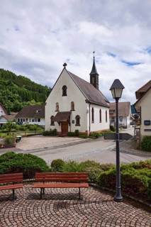 Chapel St. Josef, benches, lantern, hilly landscape with forest, crossing Bollenbacher Straße with