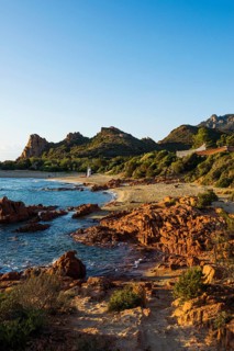 Lonely picturesque beach and red rocks, Spiaggia Su Sirboni, sunrise, near Tertenia, Province of