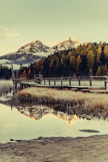 Lake Staz near Sankt Moritz in the Engadin in Switzerland. Morning atmosphere with fog in autumn.