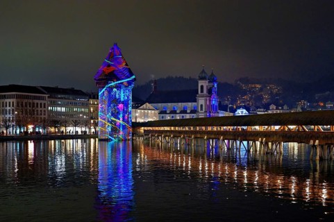 Wassertum with light installation, Chapel Bridge on the right, Jesuit Church on the Reuss at dusk