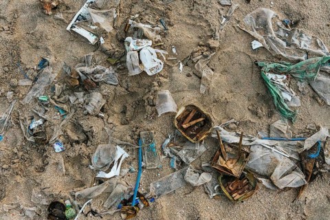 Debris on a beach in Bali signifies environmental pollution, showcasing the serious impact of waste