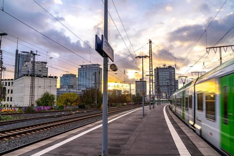 Regional train arriving at Essen central station, platform, city centre skyline, North