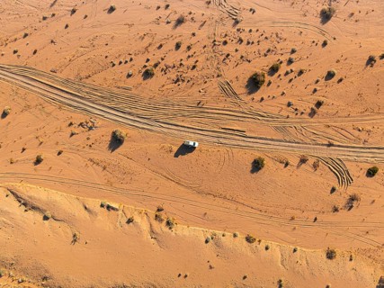Aerial view, lonely road with offroad car, desert landscape, Erongo, Damaraland, Namibia