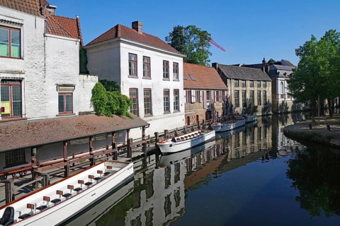 Idyllic canal with boats flanked by historic buildings, canals, Bruges, West Flanders, Belgium