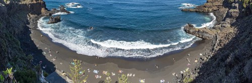 The lava beach lined with bathers, Playa del Bollulo, near Puerto de la Cruz, Tenerife, Canary