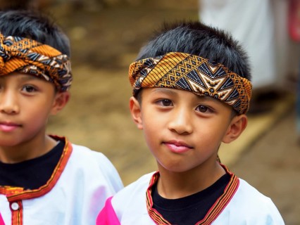 Boy in traditional festive dress, funeral ceremony, Tana Toraja, Sulawesi, Indonesia