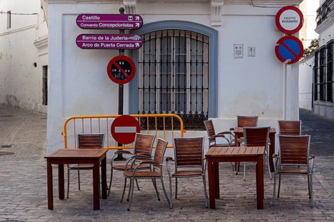 Table and chairs in the outdoor catering area, Vejer, Andalusia, Spain