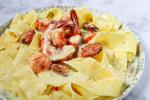 Papardelle pasta in creamy sauce with seafood, homemade, no people