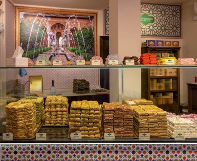 Colourful sweets in a shop window decorated with oriental tile patterns, Cordoba, Spain