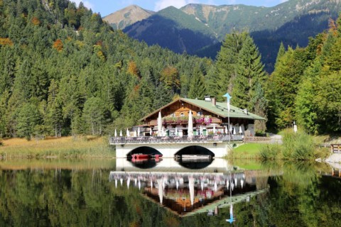 The picturesque Pflegersee lake near Garmisch, with the mountain inn in the background