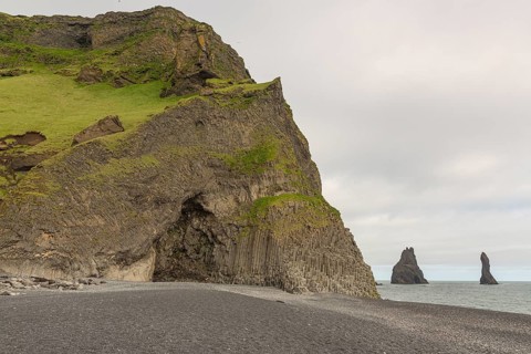 Reynisfjara Beach with Basalt rocks (Stuolabrrg) and the rock needles (Haidrangur), close to Vik i