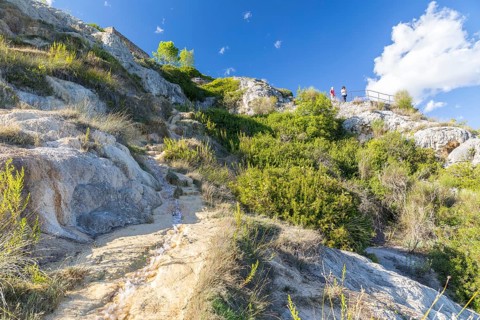 Watercourse in the limestone alternates with waterfalls on the steep slope of the Orcia Valley in