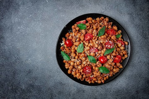 Tuscan pasta with smoked paprika and basil, parmesan cheese, Italian traditional cuisine
