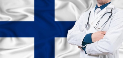 Finland Health Care concept. Male doctor on Finland flag. Doctor with crossed arms on Finland flag