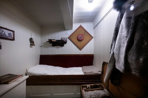 Cabin with small bed and dartboard, historic polar research ship Fram, wooden ship, by Fridtjof